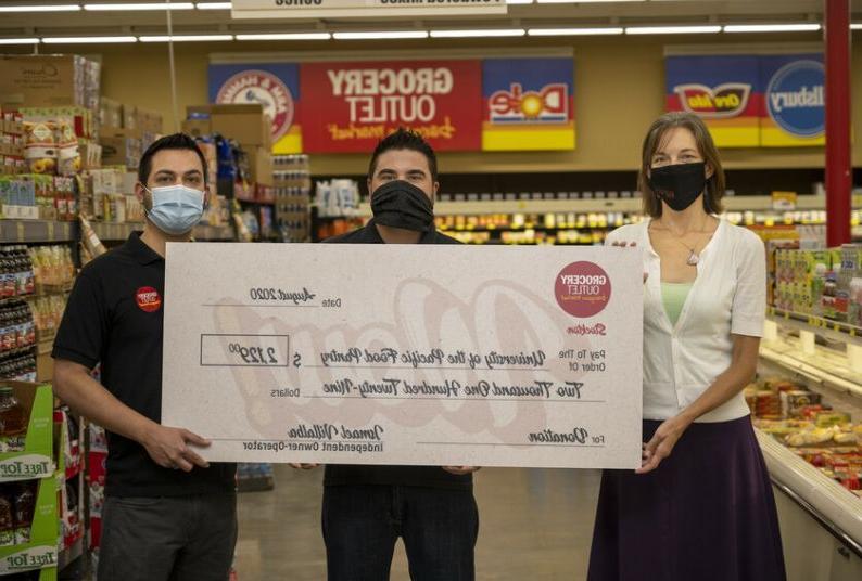 Jessica Bilecki of Pacific's food pantry with Ismael Villalba and Jesus Valenzuela, co-owners of the Grocery Outlet on North Wilson Way in Stockton.