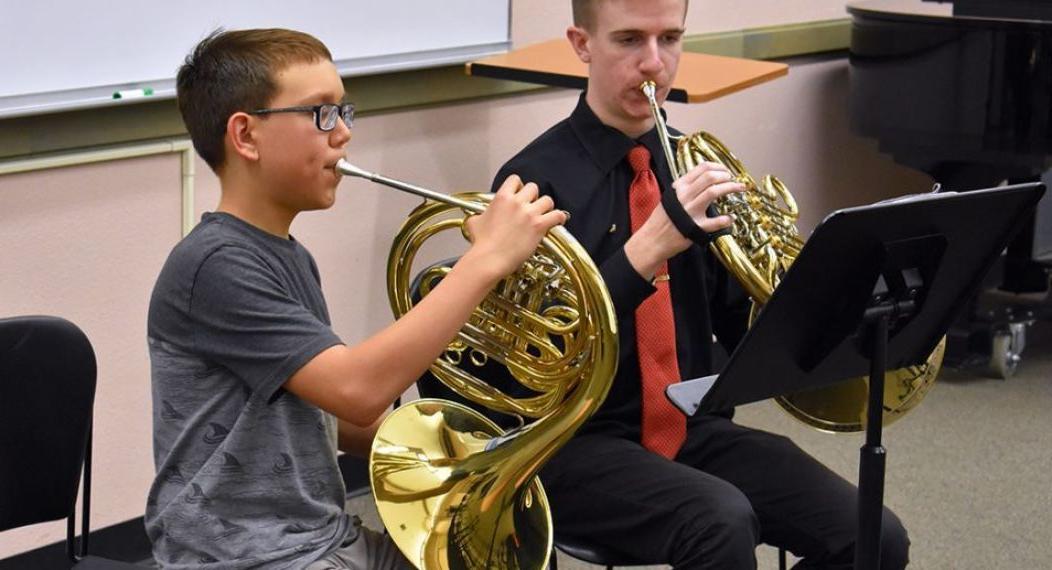 two music students practicing the horn